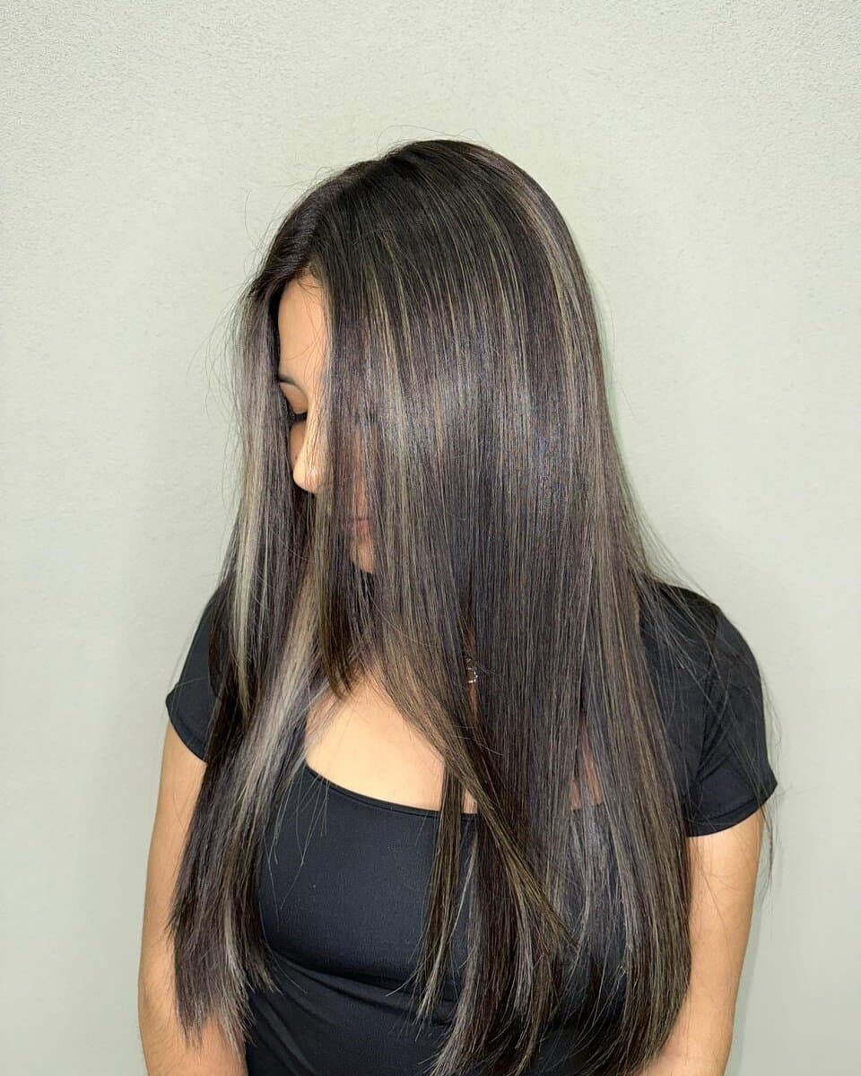Long, straight dark hair with fine beige highlights throughout
